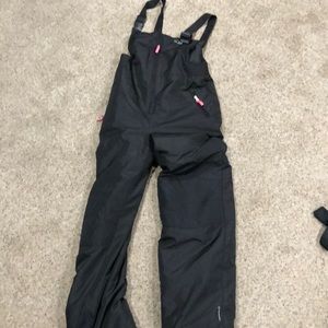 Black ski bibs with pink zipper tie